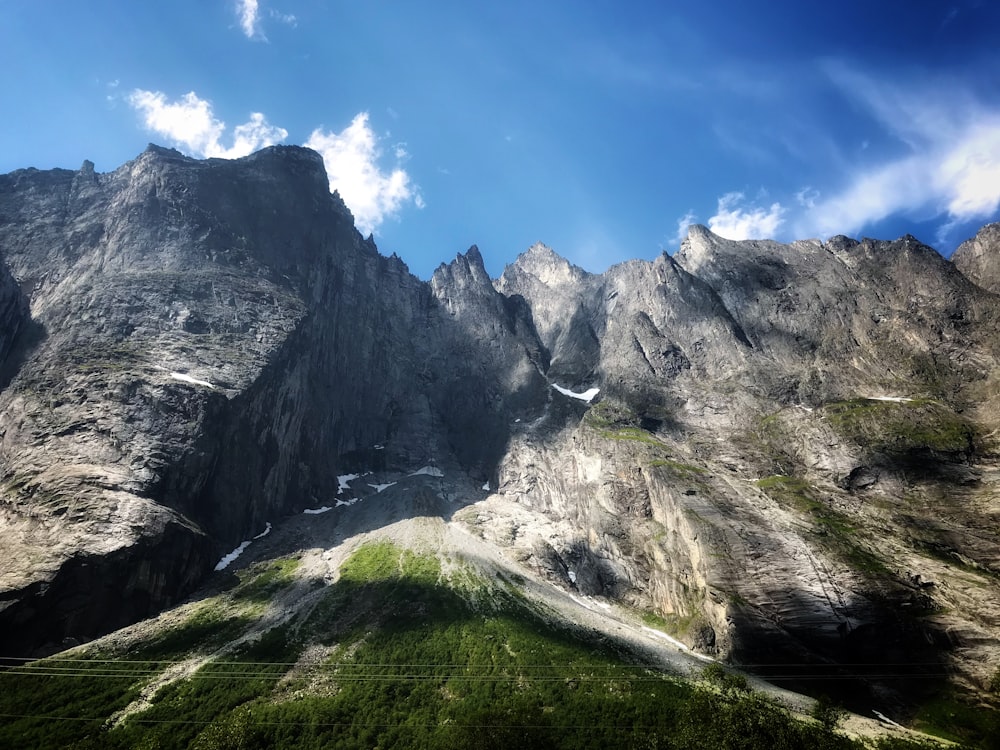 gray rocky mountain under blue sky during daytime