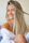 woman in white off shoulder shirt smiling