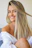 woman in white off shoulder shirt smiling