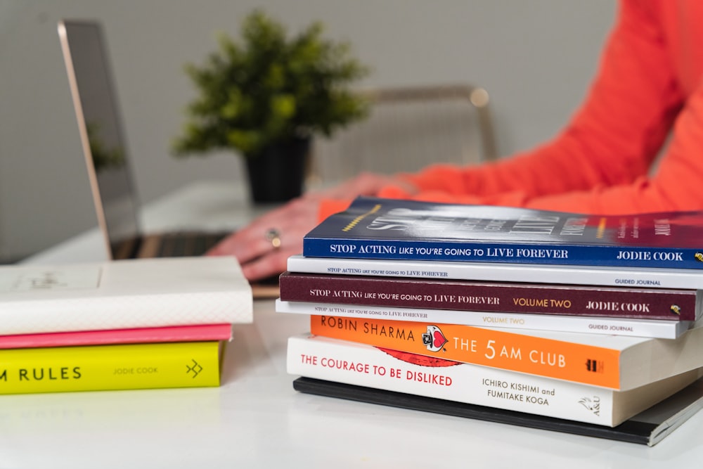 stack of books on white table