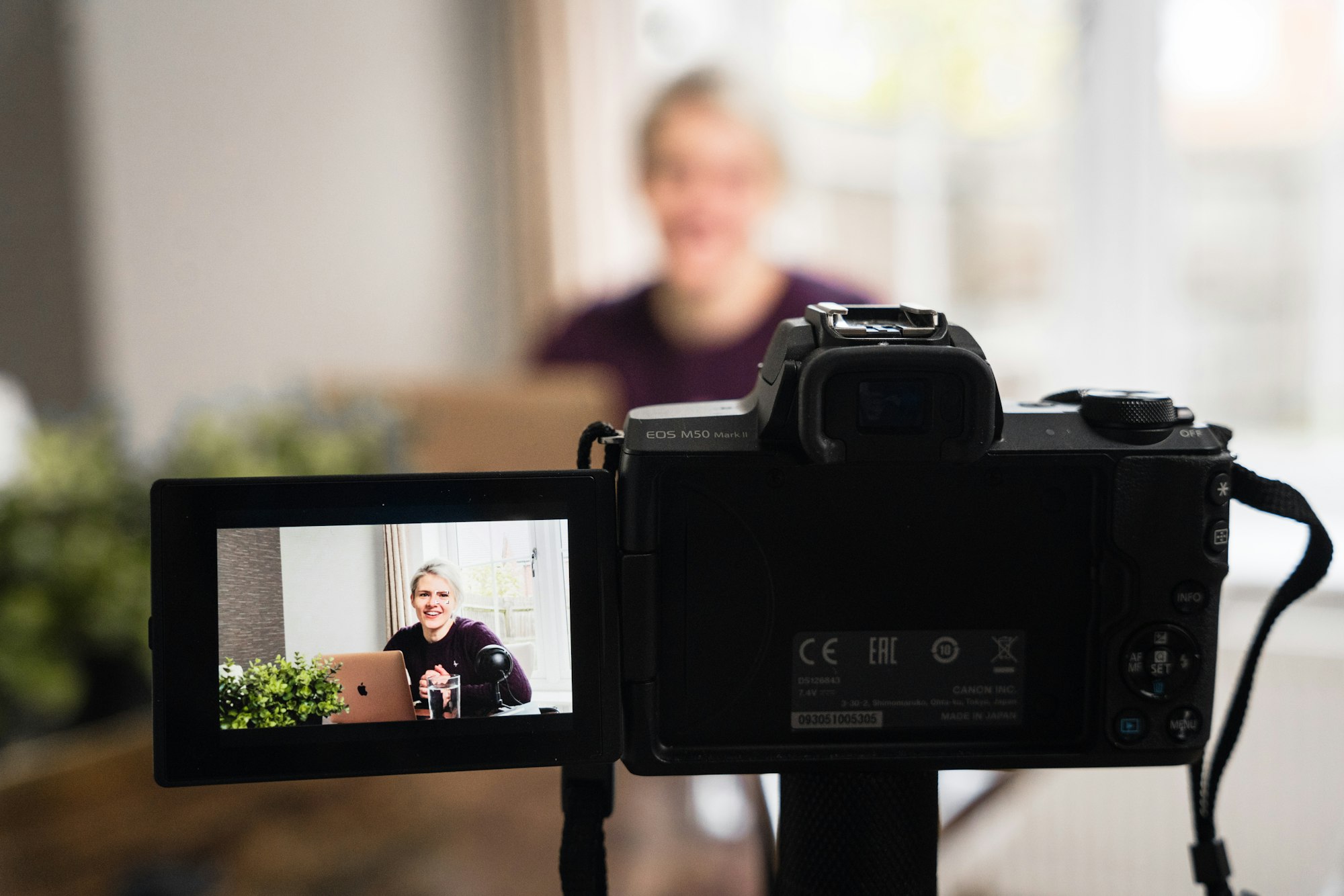 A business owner speaks into a DLSR camera on a tripod