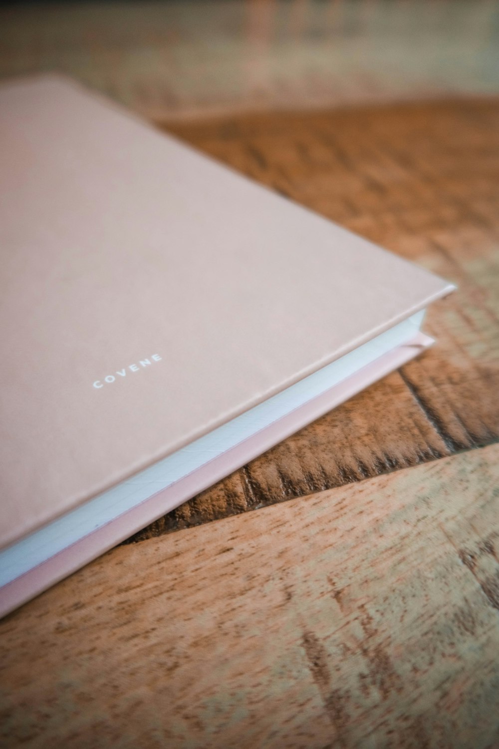 white book on brown wooden table