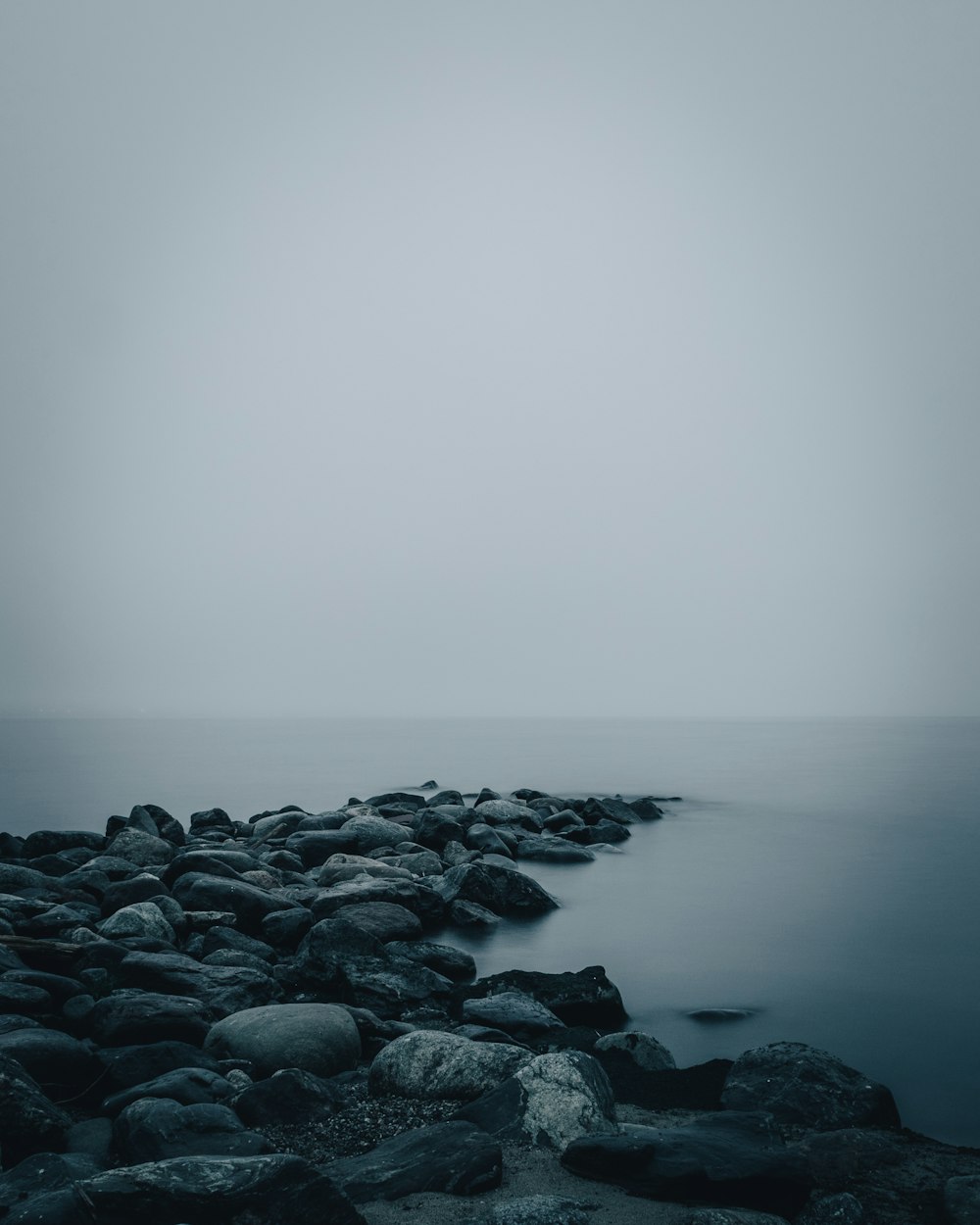 gray rocks on body of water