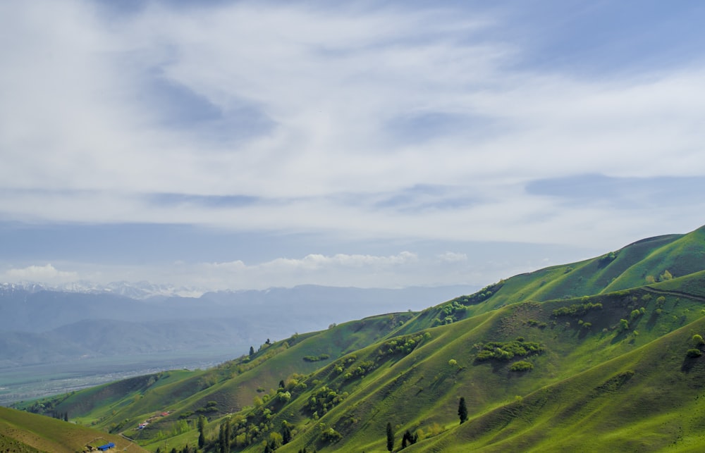 green mountains under white clouds during daytime