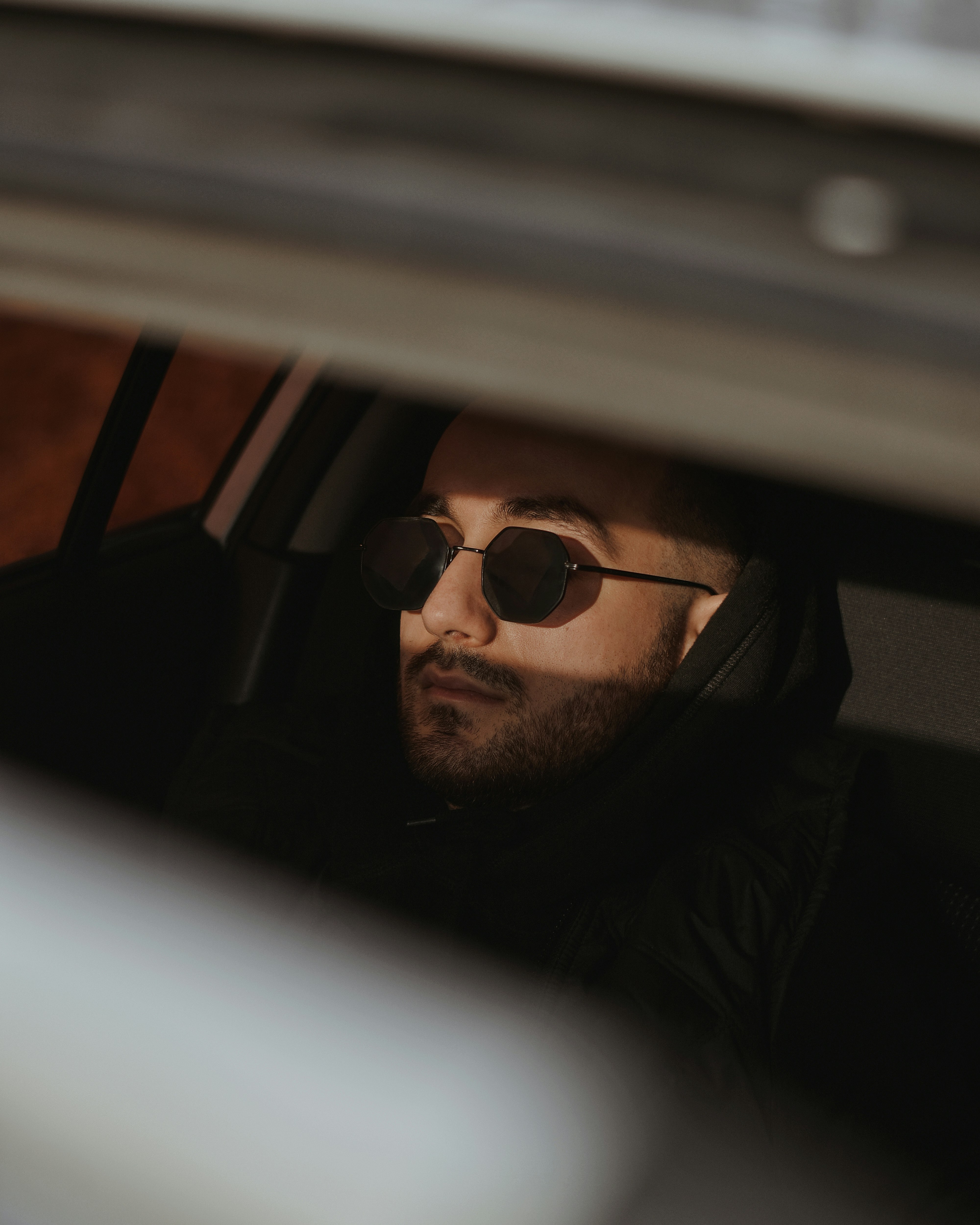 man in black jacket wearing black sunglasses