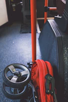 Close-up of a Trygvogn stroller’s adjustable handle and durable wheels on a gravel path.