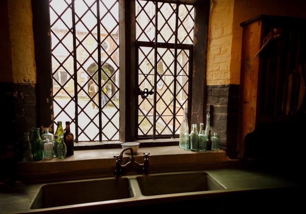 white ceramic sink near window