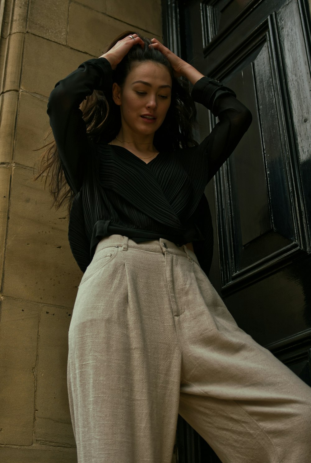 woman in black long sleeve shirt and beige skirt