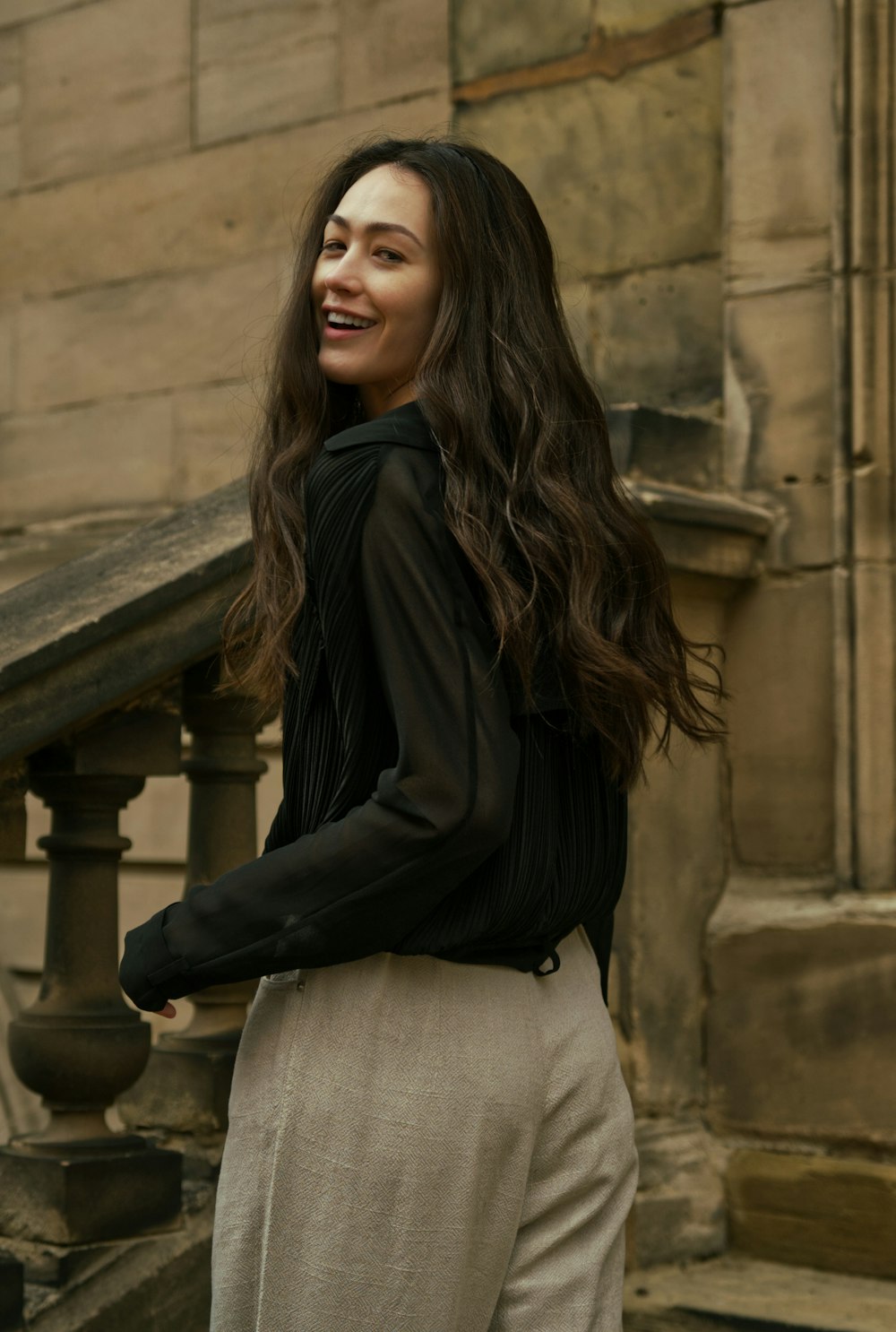 woman in black long sleeve shirt and white denim jeans