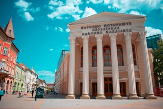 people walking near white concrete building during daytime