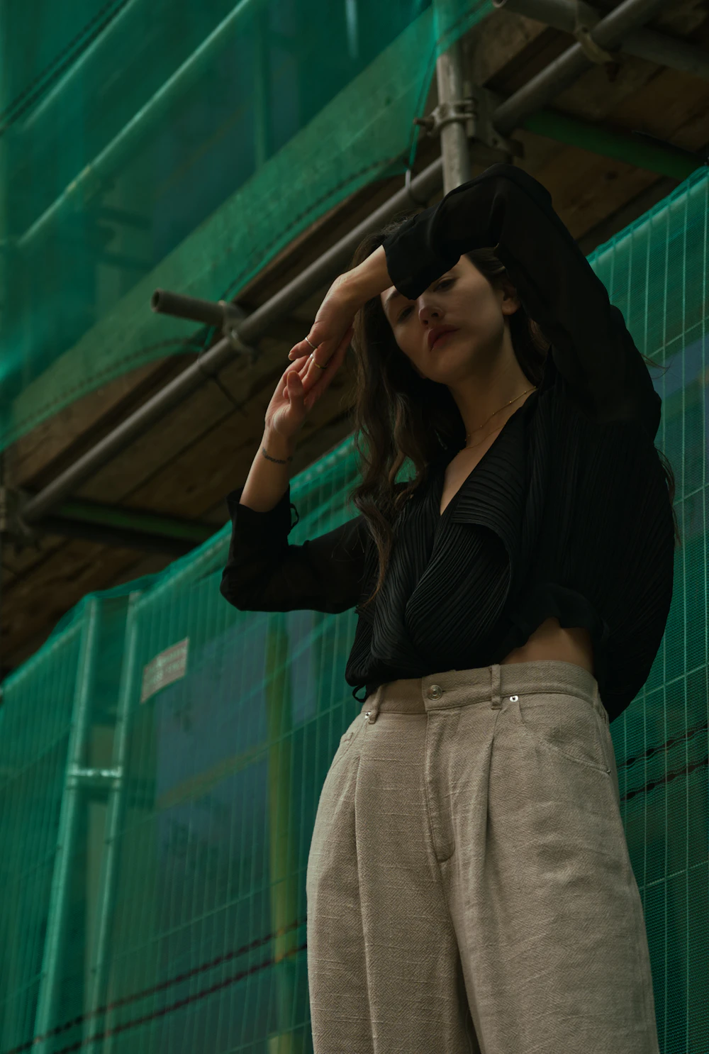 Sheer black blouse with stone wide-leg trousers