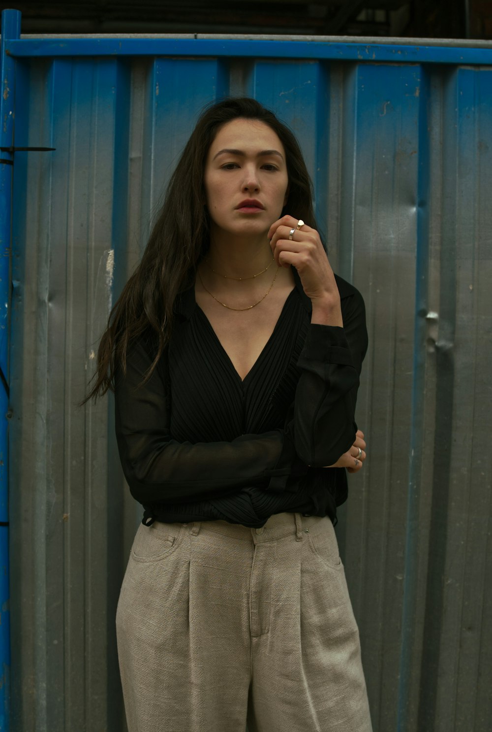 woman in black long sleeve shirt and beige skirt