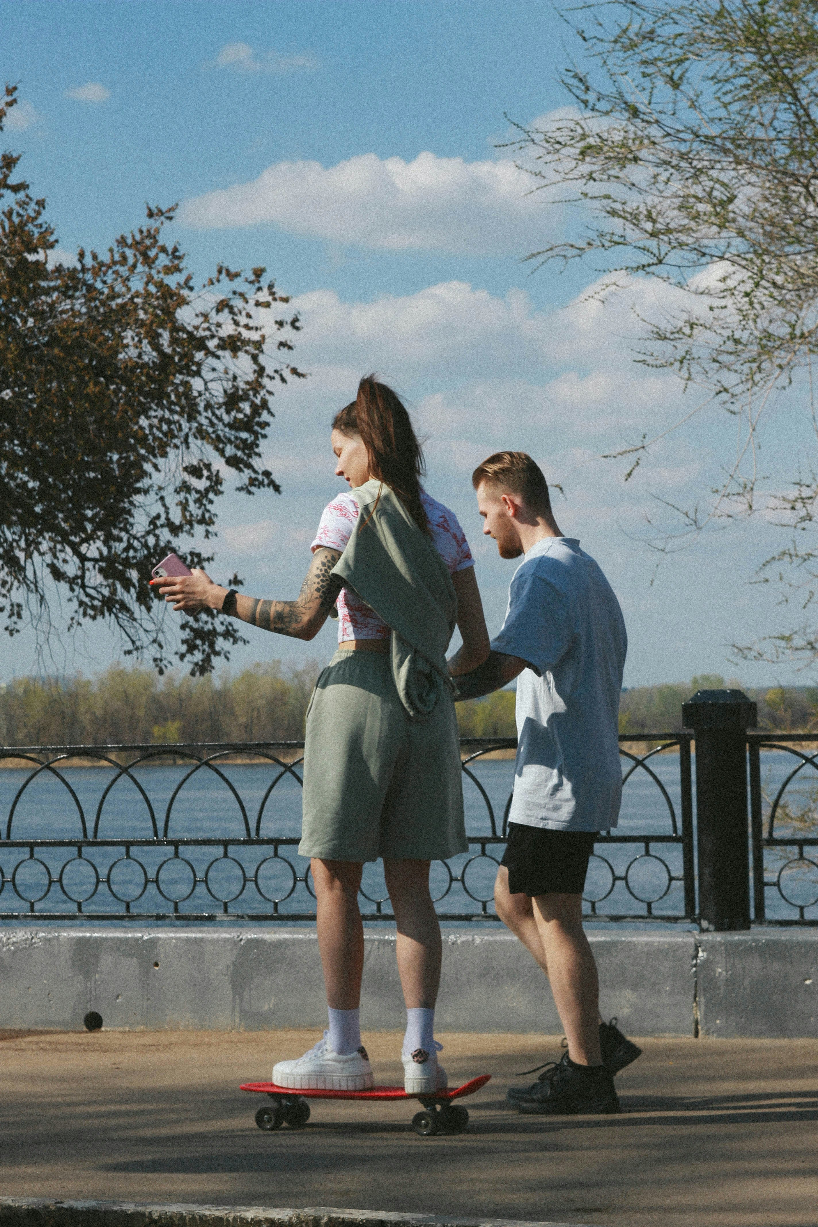 man and woman standing on gray concrete floor during daytime