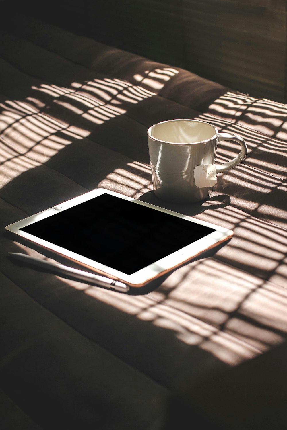 white ipad on brown and white stripe textile