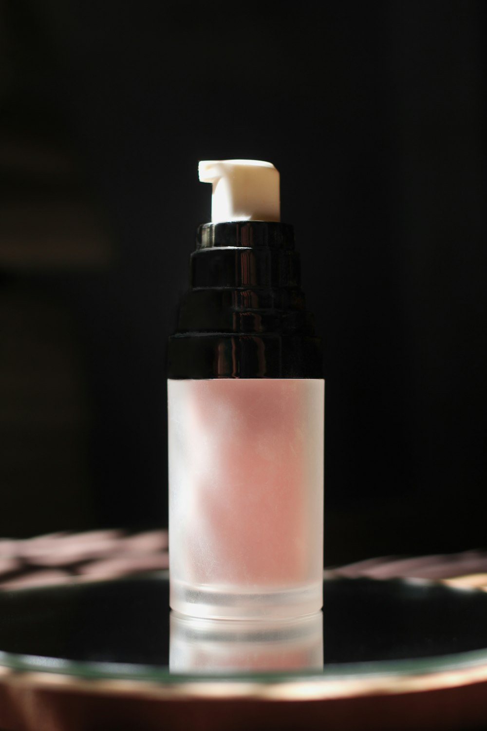 white and black bottle on brown wooden table