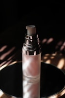 Close-up of a radiant serum bottle catching soft natural light.