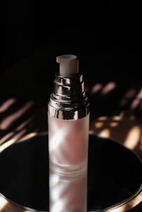 Close-up of shimmering body splashes in translucent bottles with subtle copper accents.