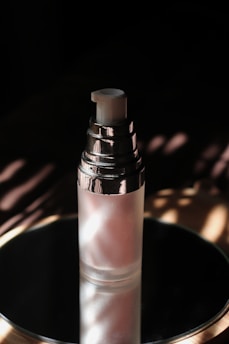 An elegant bottle of lubricant with soft lighting highlighting its smooth texture.