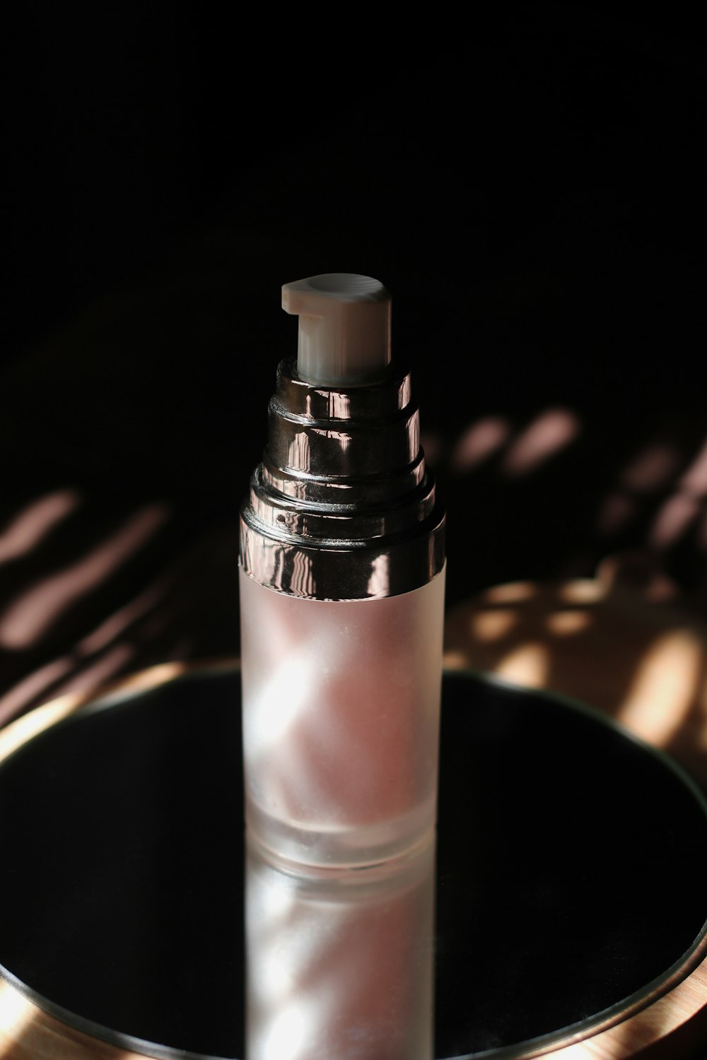 clear glass bottle with black lid