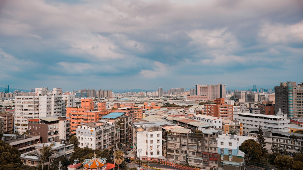 city buildings under white clouds during daytime