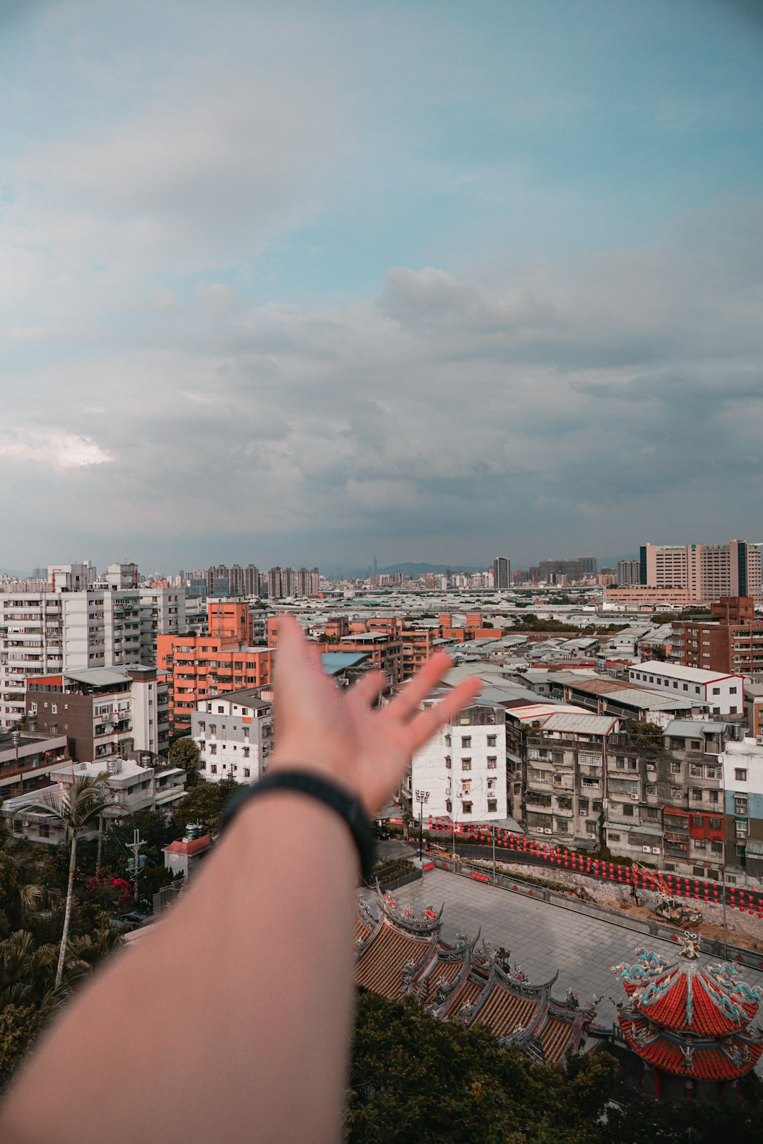 person in black bracelet holding the hand of the city during daytime