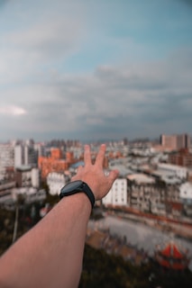 A compact smartwatch glowing softly on a wrist, with a blurred cityscape in the background.