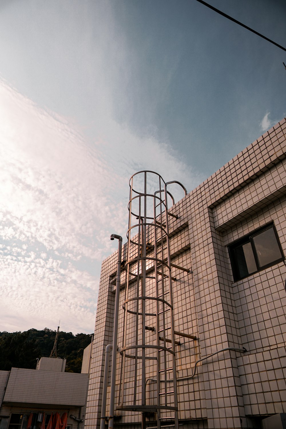 brown concrete building under white clouds during daytime