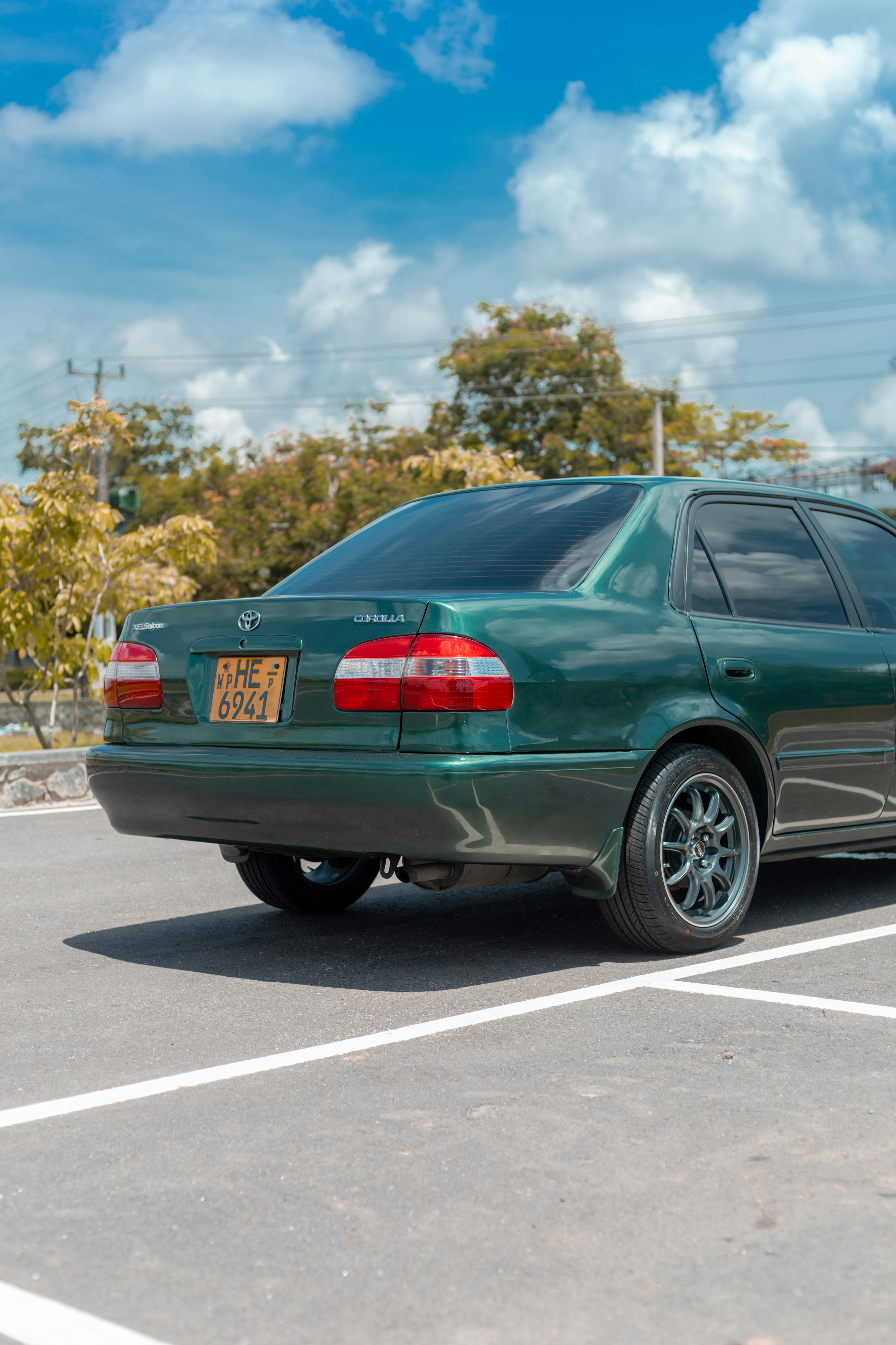 Blue compact sedan parked in clean bright lot, well-maintained appearance