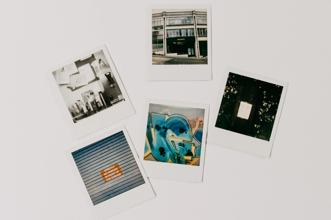 Photos pinned on a white wall