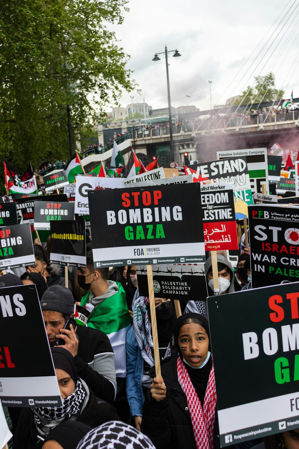 people holding signage during daytime