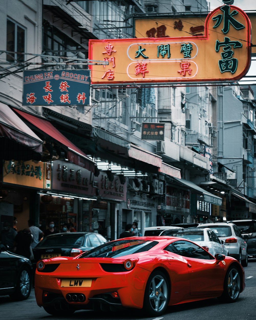 red car on the street during daytime