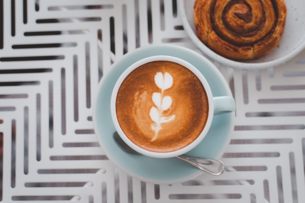 white ceramic mug with cappuccino