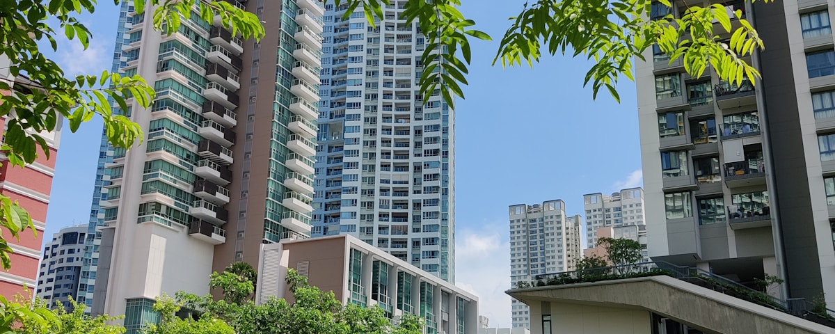 green grass field near white concrete building during daytime