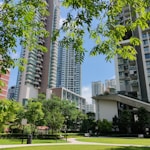 green grass field near white concrete building during daytime