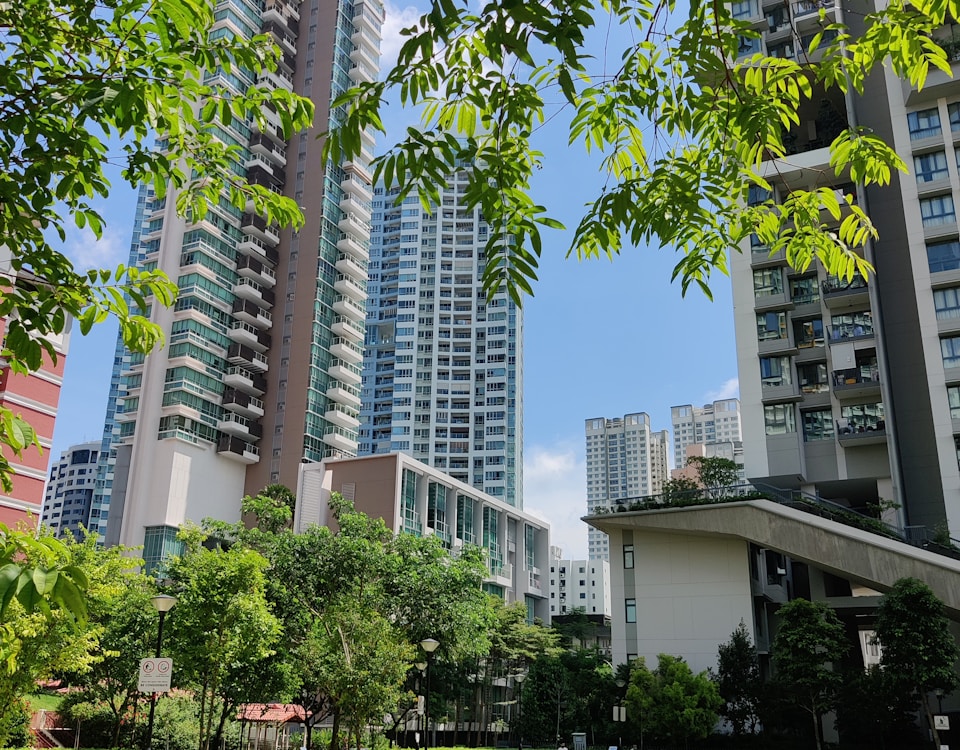 green grass field near white concrete building during daytime