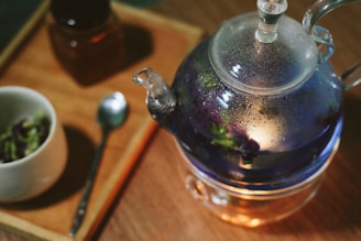 stainless steel teapot on brown wooden table