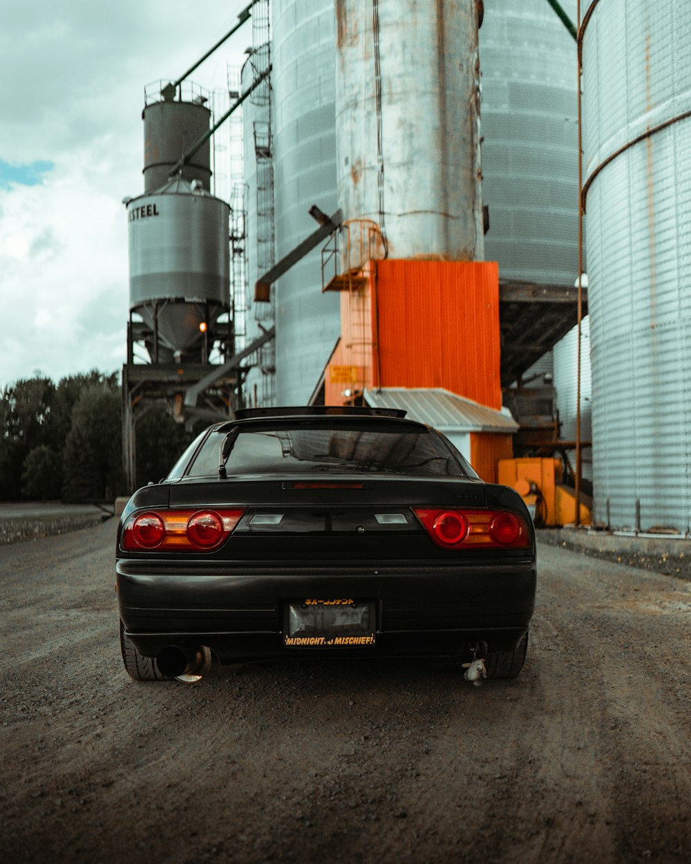 black porsche 911 parked near white building