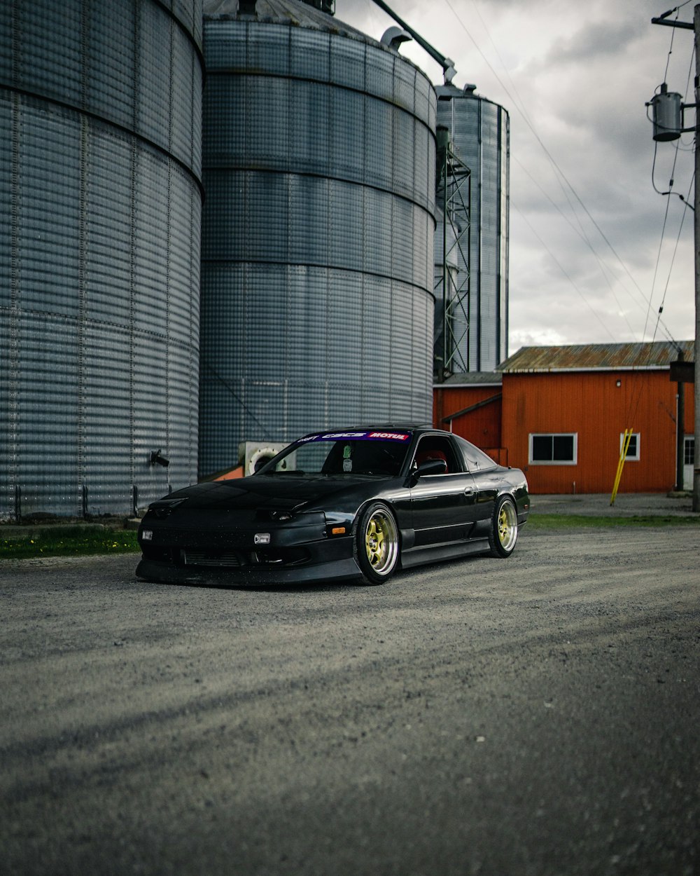 black sedan parked beside building