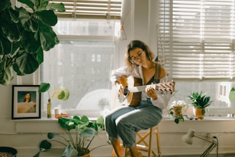 woman in white shirt and blue denim jeans sitting on chair