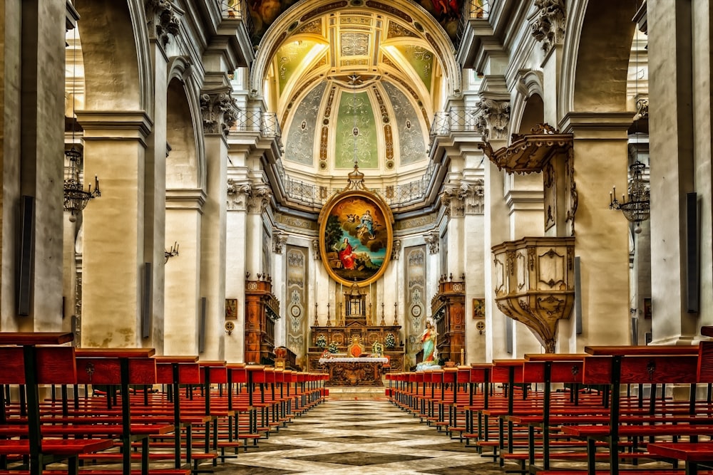 red chairs inside white and gray cathedral