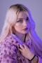 woman with purple hair wearing purple and white fur coat