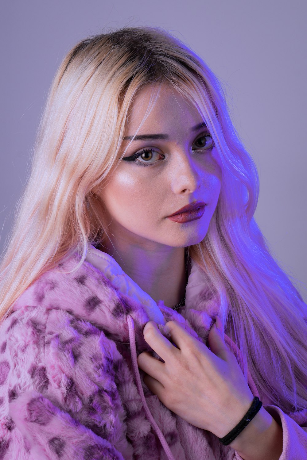 woman with purple hair wearing purple and white fur coat