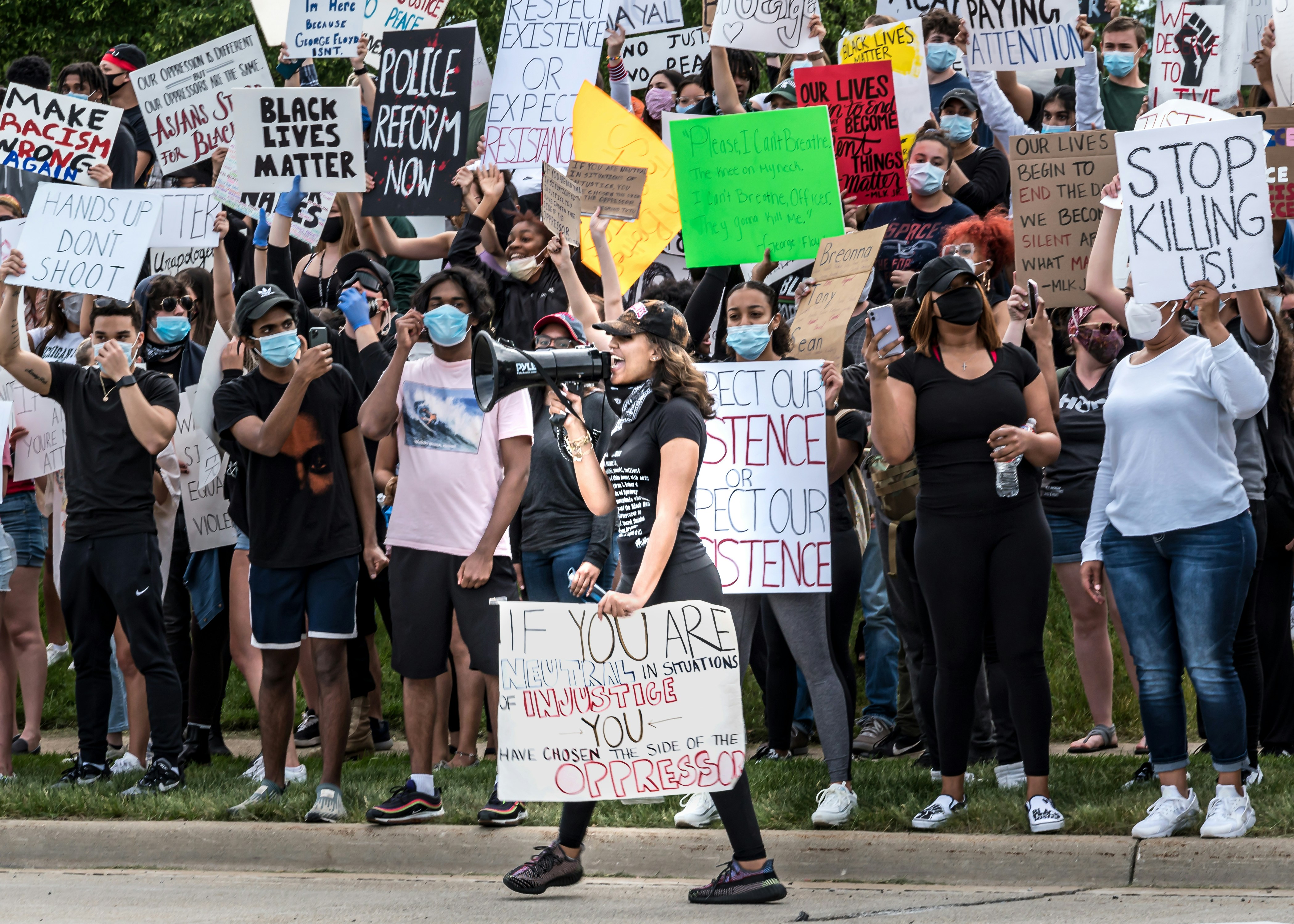 people holding a signage during daytime