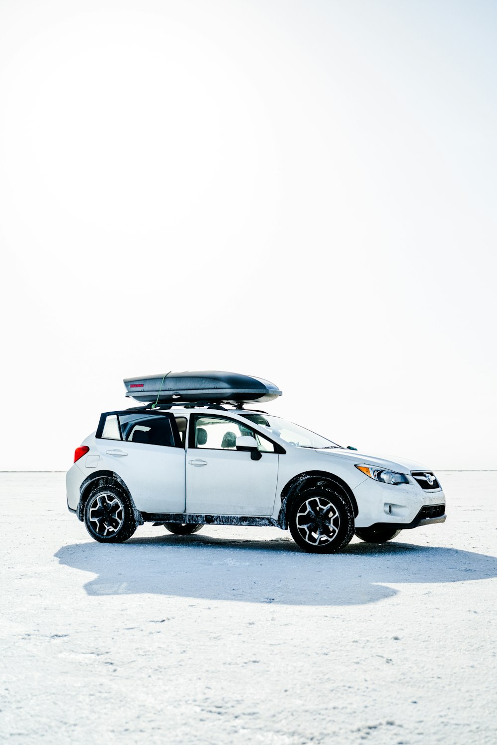 white and black suv on white snow covered ground