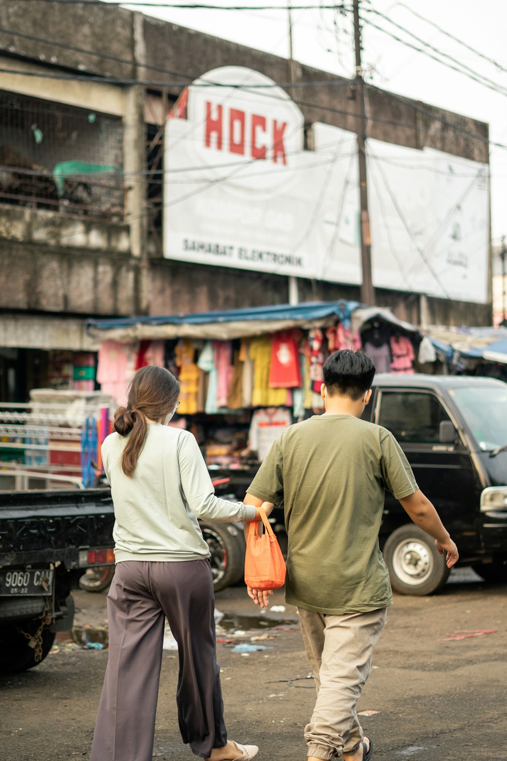 man in gray t-shirt and gray pants standing beside woman in white long sleeve shirt