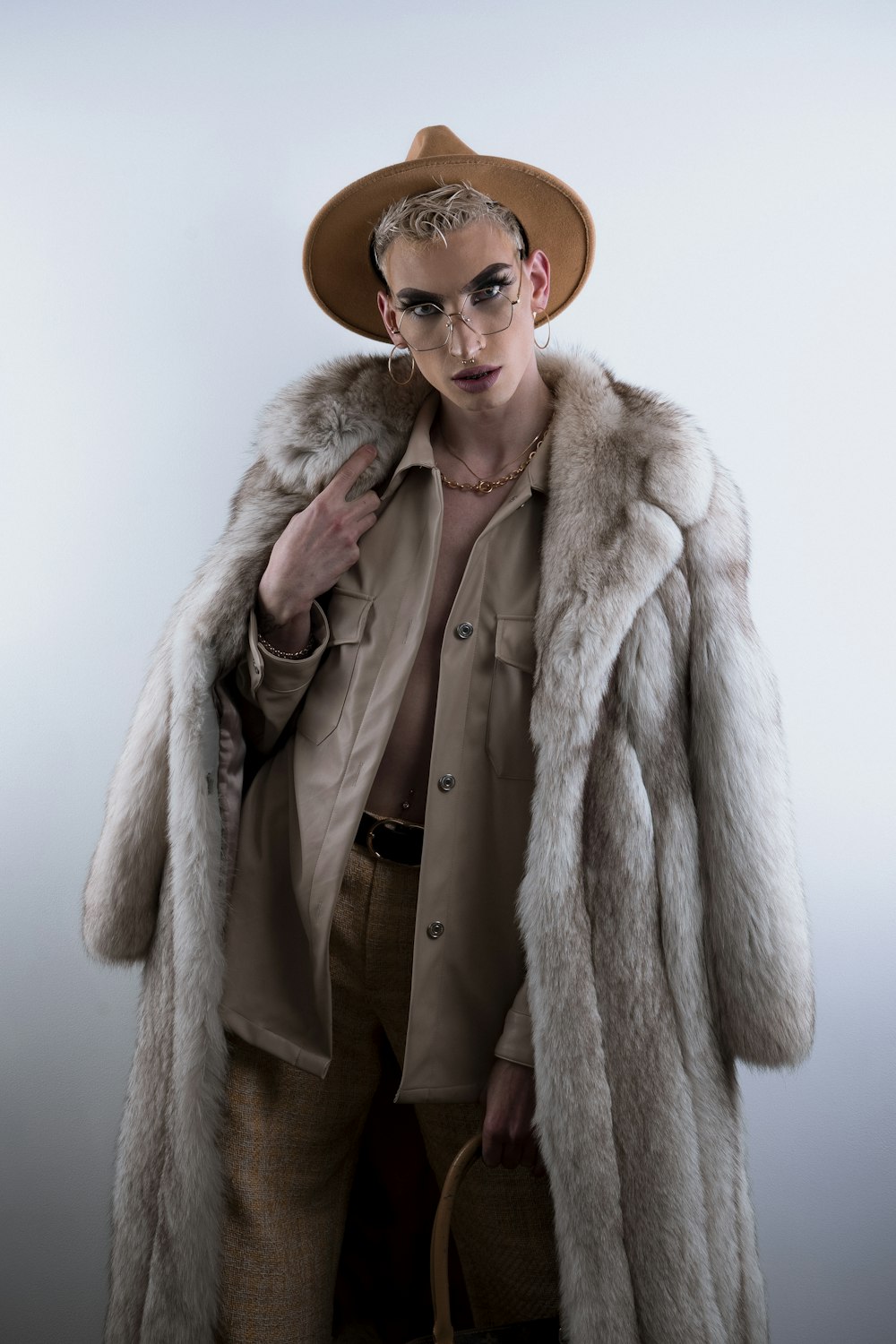 woman in brown coat wearing brown sunglasses