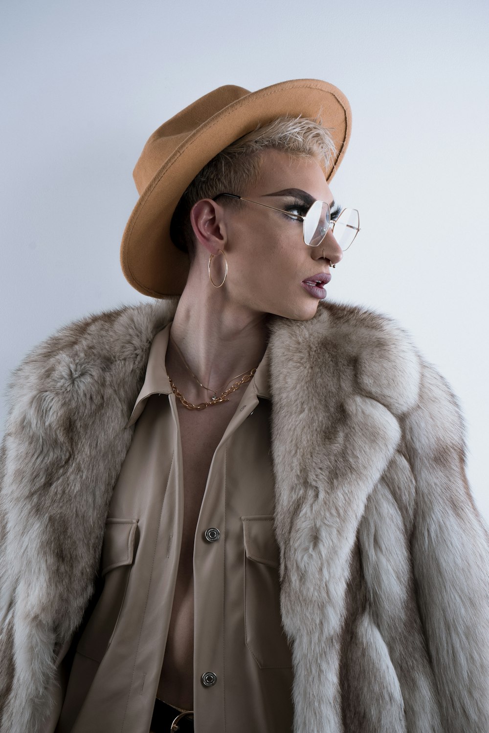 woman in brown coat wearing brown sunglasses