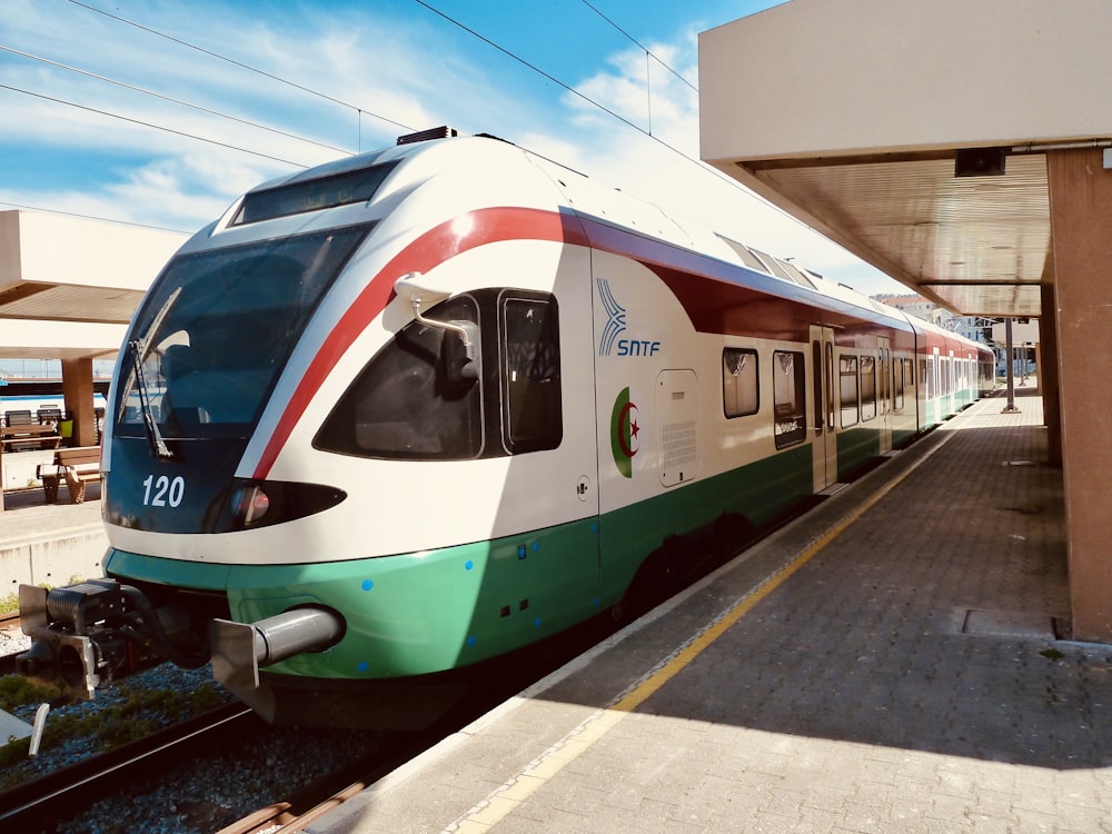 white and blue train on rail during daytime