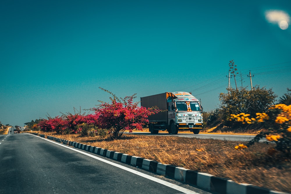 blue and white truck on road during daytime