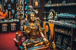 gold buddha figurine on brown wooden table